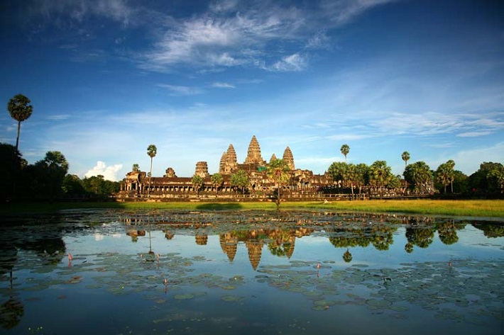 Angkor Wat seen from across a lake on a sunny day in Cambodia